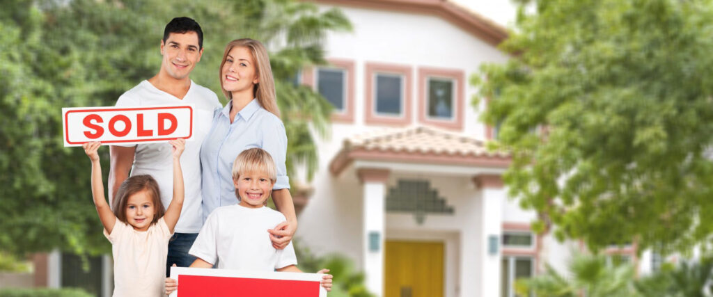 Young family standing in front of a home they purchased through a real estate representative